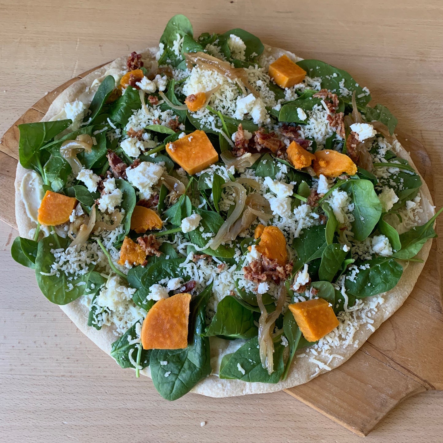 Feature Pizza- Béchamel sauce, roasted yams, caramelized onions, spinach, bacon, mozzarella, chevre
