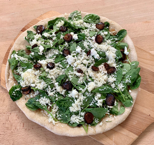 Fig and Chevre Pizza- Spinach, caramelized onions, figs, mozzarella, chèvre (goat cheese), fresh rosemary, cracked pepper
