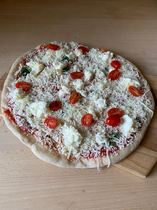 Margherita Pizza- Tomato sauce, fresh tomatoes, basil, bocconcini, mozzarella
